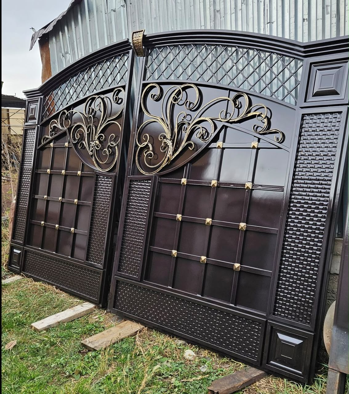 Dark ornate gate with gold filigree scrollwork