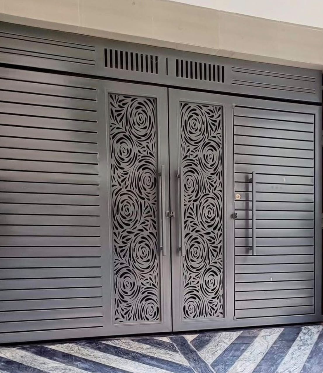 Gate with laser-cut rose pattern panels