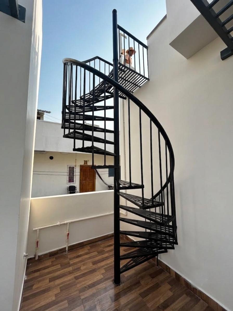 Custom black spiral staircase fabricated and installed by Shoukat Fabrication