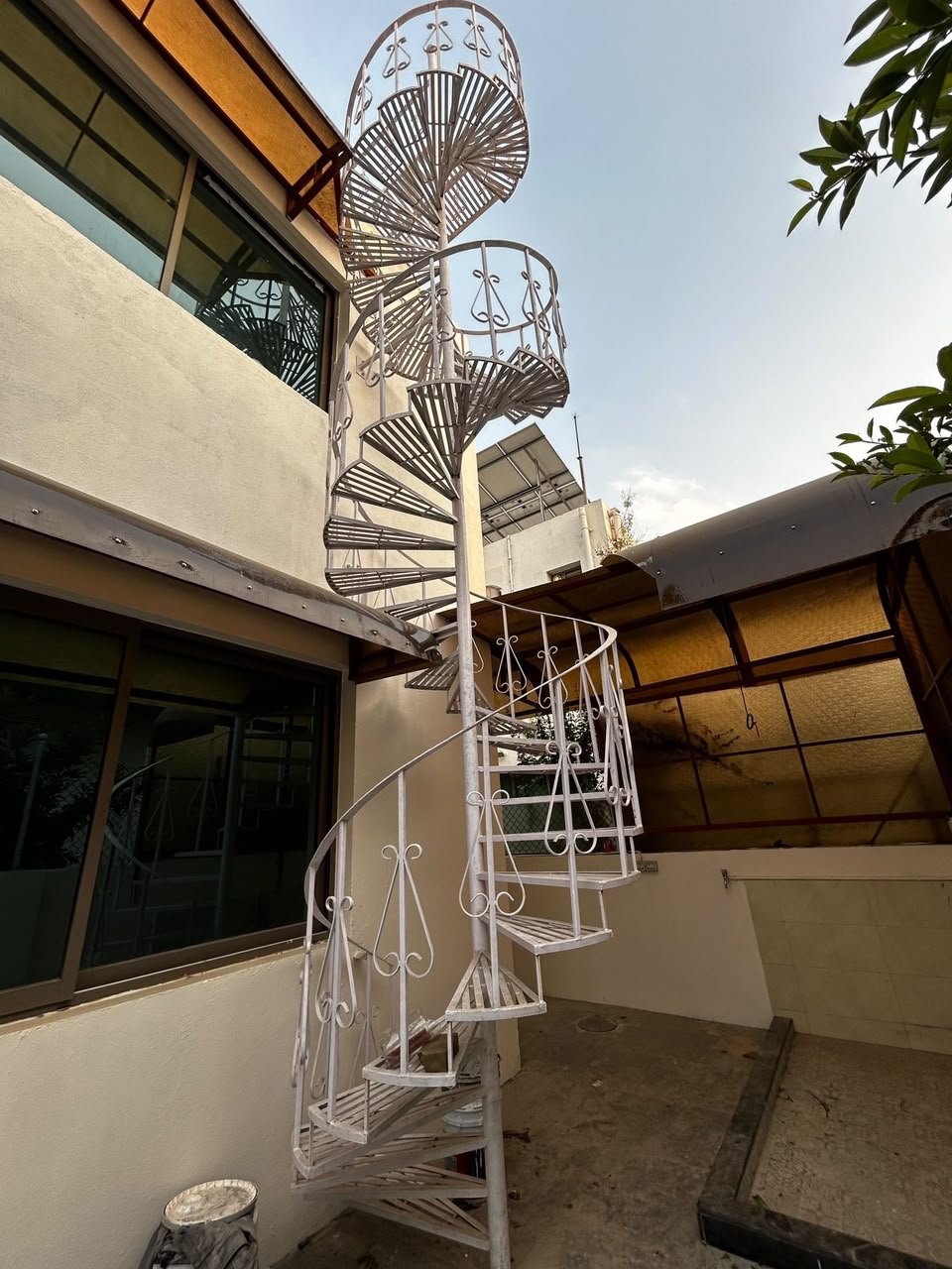White spiral staircase installed on a residential terrace