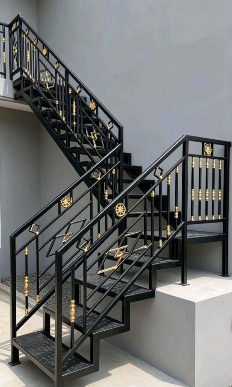 Black staircase railing with gold diamond accents